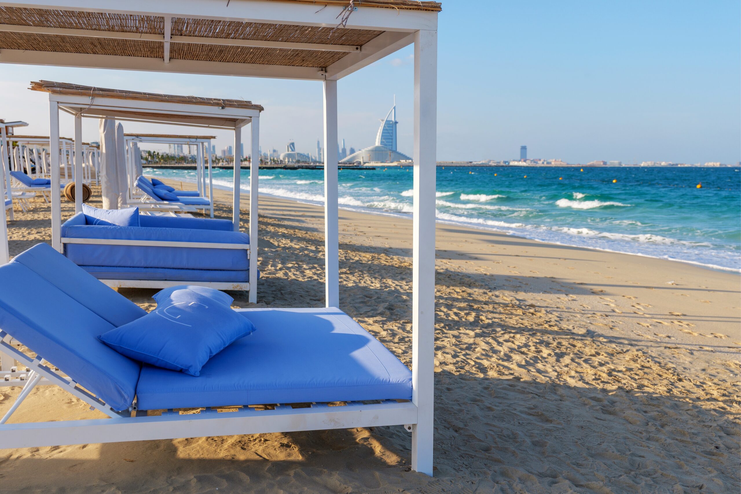 Beach,Cabanas,With,Blue,Mattresses,On,A,Sandy,Shore,In